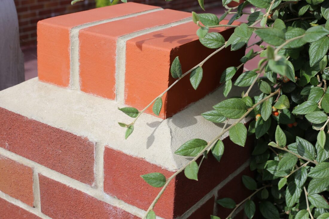 Hand-built brick pier with decorative capping and crisp pointing