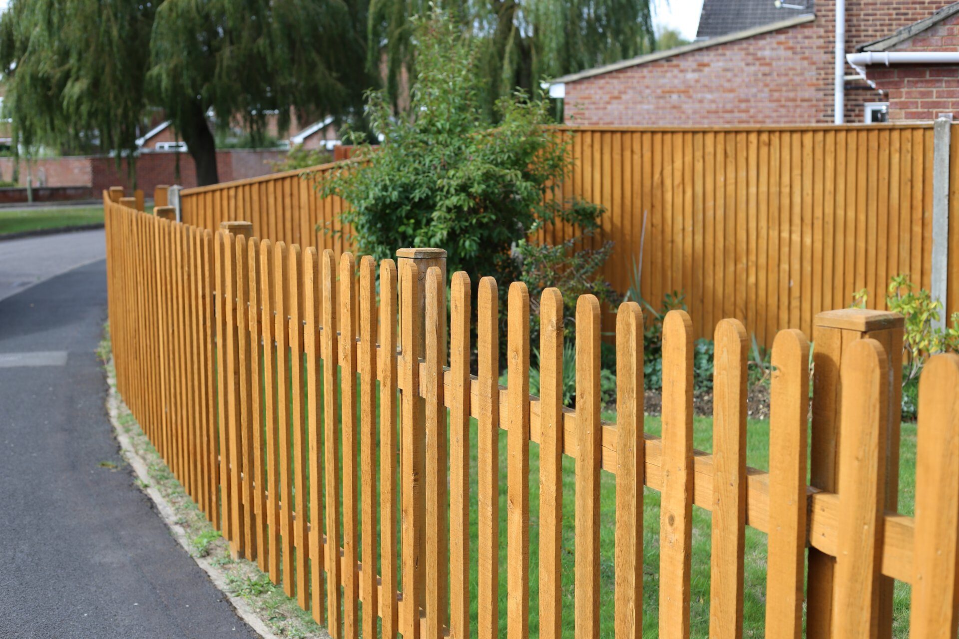 New timber fence with paved driveway