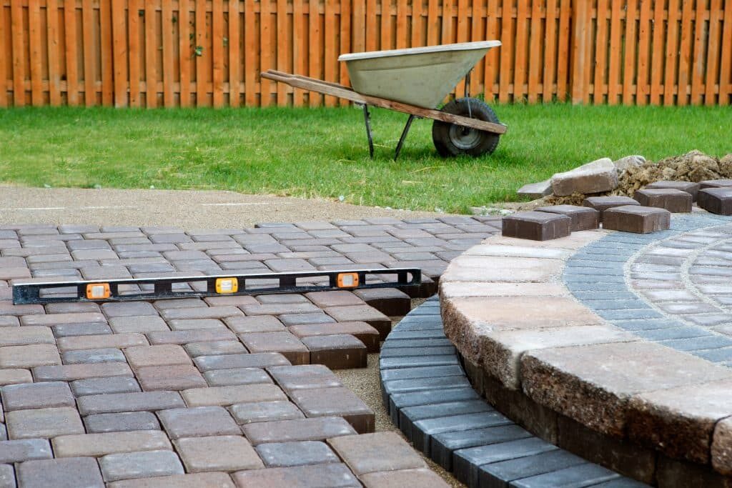 Retaining wall and stepping levels being installed in a sloped garden